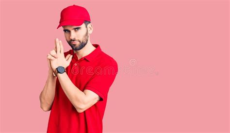 Young Handsome Man With Beard Wearing Delivery Uniform Holding Symbolic