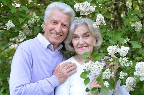 Premium Photo Portrait Of Beautiful Senior Couple By Lilacs In The Park