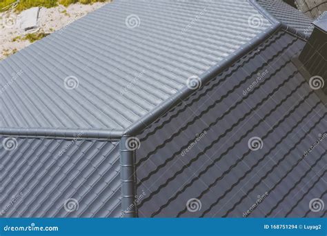 Gray-blue Metal Roof Tiles on the Roof of the House. Corrugated Stock ...