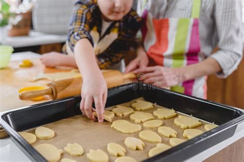 Grandmother Baking Cookies With Her Grandchildren At Home Stock Image