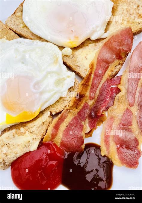 English Breakfast With Toast Fried Eggs Crispy Streaky Bacon With Red