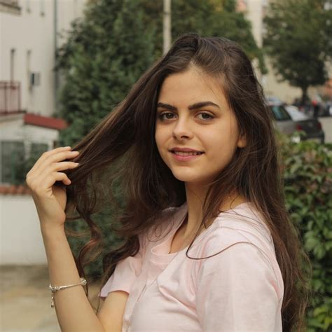 Premium Photo Portrait Of Smiling Girl Standing Outdoors