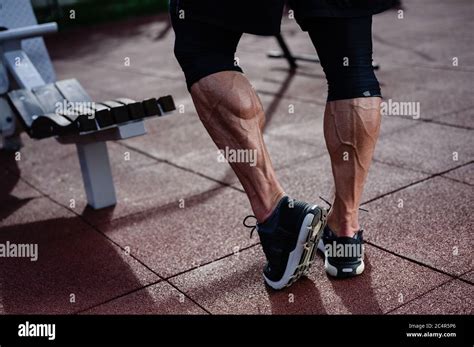 Strong Athlete Legs Of Man In Sneakers On Outdoor Training Workout