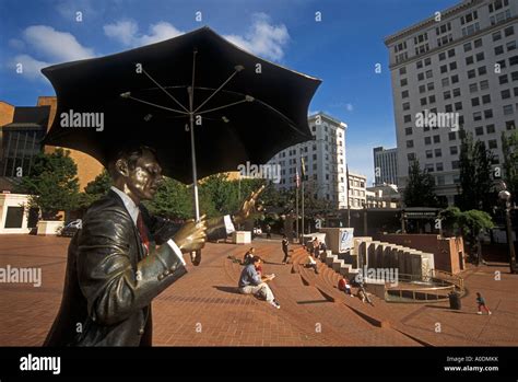 Statue Of Man With Umbrella In Pioneer Courthouse Square Downtown