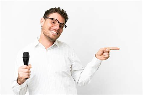 Premium Photo Brazilian Man Picking Up A Microphone Over Isolated