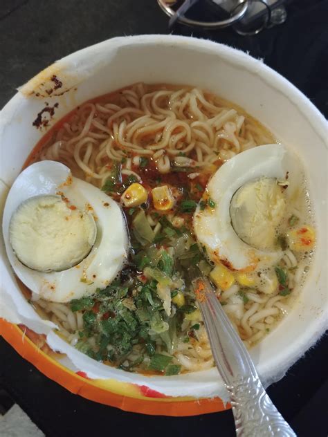 Bowl microwave ramen noodles with 2 halves of a hard boiled egg on top ...