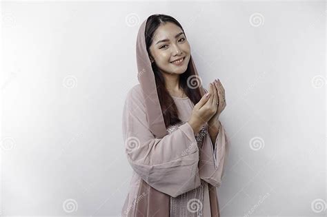 Religious Beautiful Asian Muslim Girl Wearing A Headscarf Praying To God Isolated By White