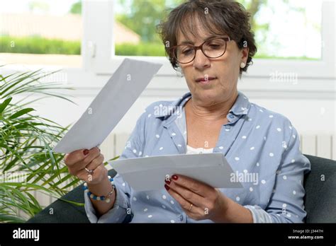 Beautiful Mature Woman Opens The Mail At Home Stock Photo Alamy