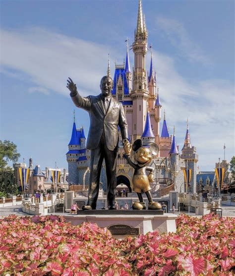 Walt Disney and Mickey Mouse Statue in front of Cinderella Castle