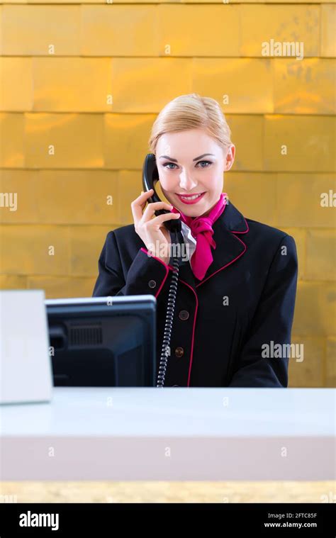 Female Hotel Receptionist Talking On Telephone Hi Res Stock Photography