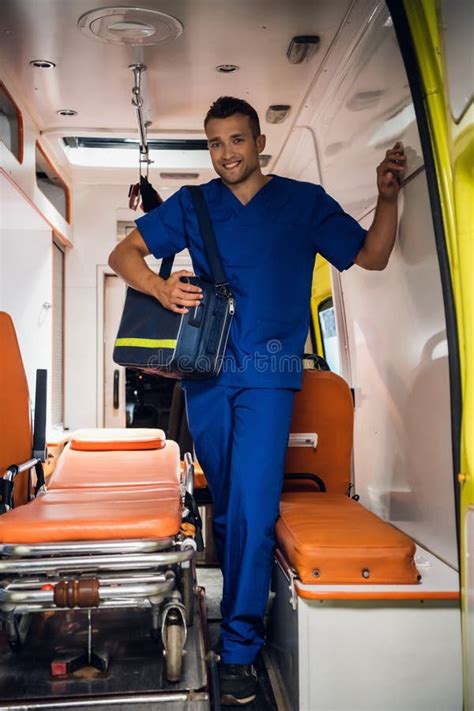 Paramedic Presses An Oxygen Mask To A Woman`s Face Who Is Lying On A