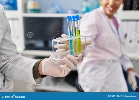 Man And Woman Scientists Partners Holding Test Tubes At Laboratory