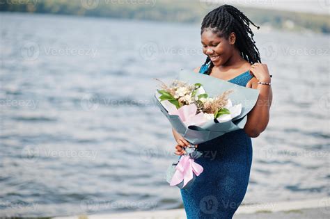 African American Dark Skinned Plus Size Model Posed In A Blue Shiny