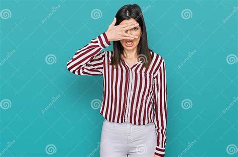 Beautiful Brunette Woman Wearing Striped Shirt Peeking In Shock