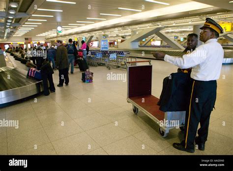 A luggage porter at the baggage claim area of Terminal 4 at JFK Stock Photo: 7212047 - Alamy