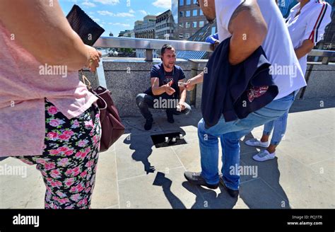 Man Illegally Performing The Cups And Ball Trick Three Shell Game On