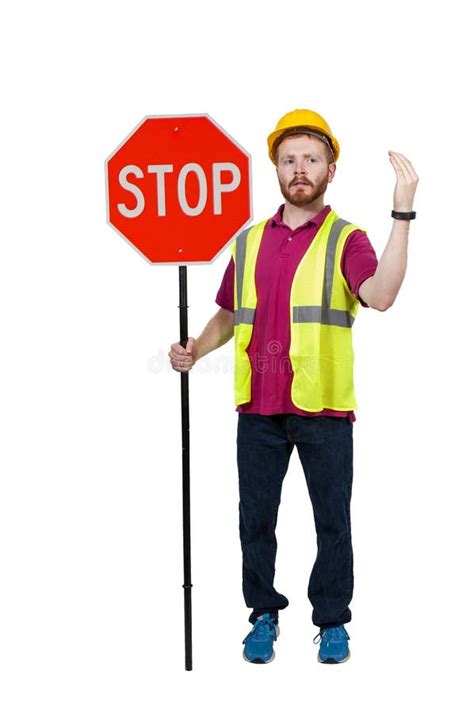 Construction Worker Holding Stop Sign On City Street Stock