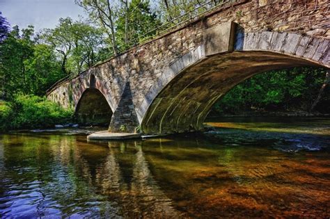 Premium Photo Arch Bridge Over River In Forest