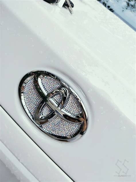 Two Rings On The Front Of A White Car