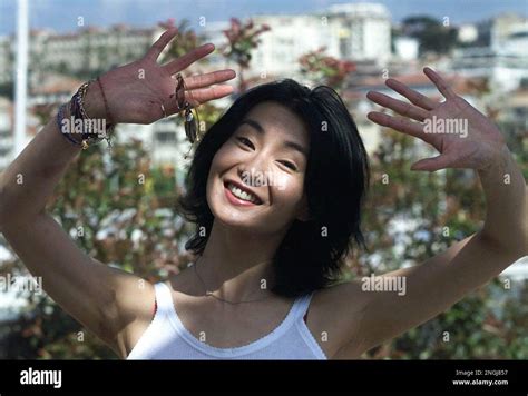 Chinese Actress Maggie Cheung Man Yuk Smiles As She Poses During A