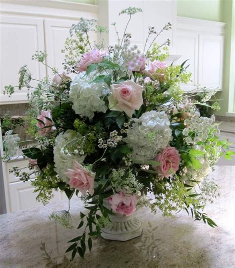 Flowers in urn. | White floral arrangements, Flower arrangements ...