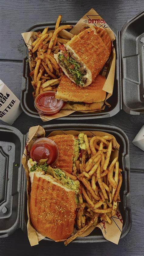 Two Trays Filled With Sandwiches And French Fries