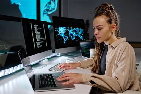 Premium Photo Young Serious Female Programmer Using Laptop By