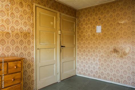Vintage Room With Pattern Wallpaper And Old Fashioned Closet And Door