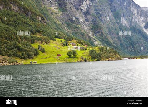 Landscape With Naeroyfjord Mountains And Traditional Village Houses In