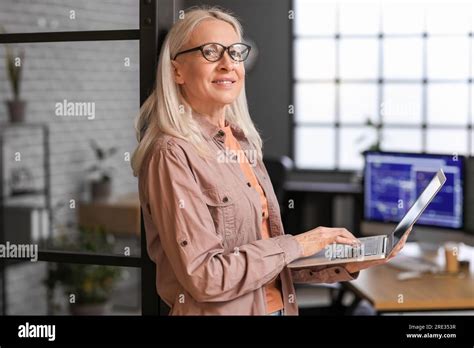 Mature Female Programmer Working With Laptop In Office Stock Photo Alamy
