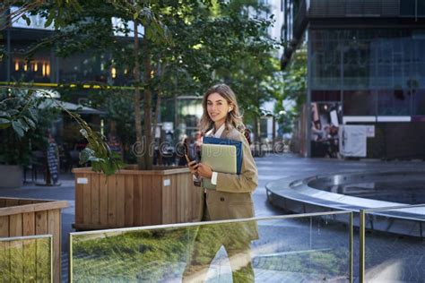 Beautiful Smiling Woman Dressed In Corporate Suit Holding Laptop And