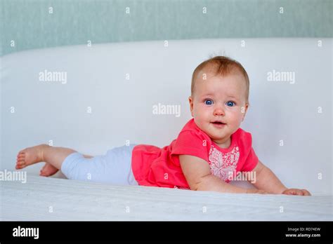 Portrait Of A Cute Newborn Baby Lying On Her Stomach Stock Photo Alamy