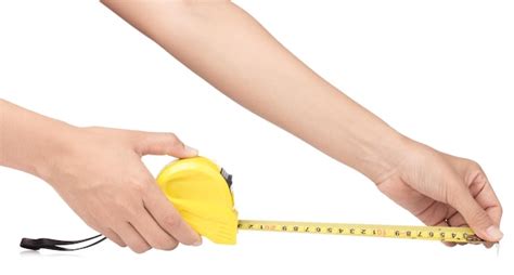 Premium Photo Hand Holding Yellow Tape Measure Isolated On White