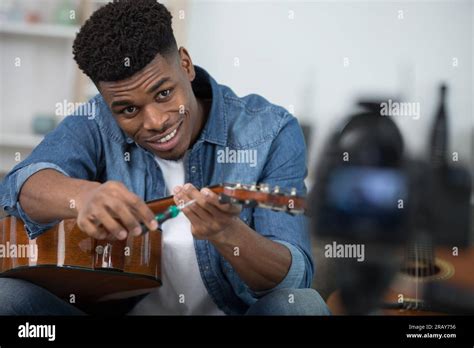Hipster Filming Tutorial On How To Tune A Guitar Stock Photo Alamy