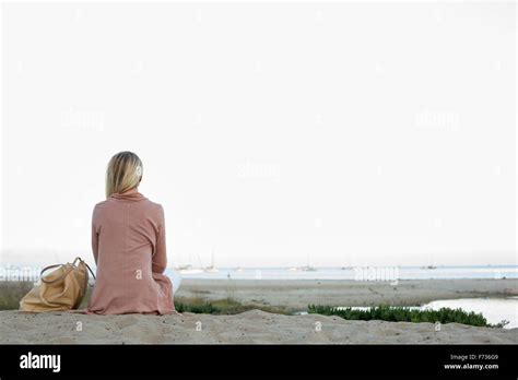 Femme Blonde Assise Sur Une Plage De Sable Banque De Photographies Et Dimages Haute