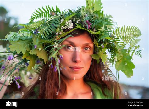 Beautiful Girl With Summer Bouquet And Summer Wreath Of Grass And