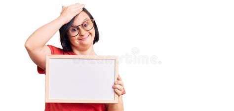 Brunette Woman With Down Syndrome Holding Empty White Chalkboard