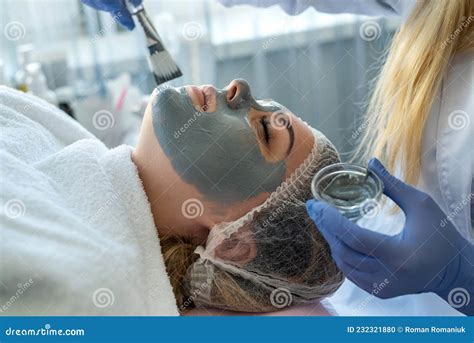 Hands Of Cosmetology Making Face Mask For Young Woman Who Relaxing