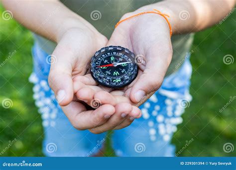 Girl Holding The Compass Hands Of A Teenager Holding A Liquid Compass Red Compass Needle