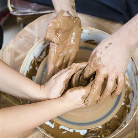 Closeup Of Hands Of Experienced Male Potter Working With Female