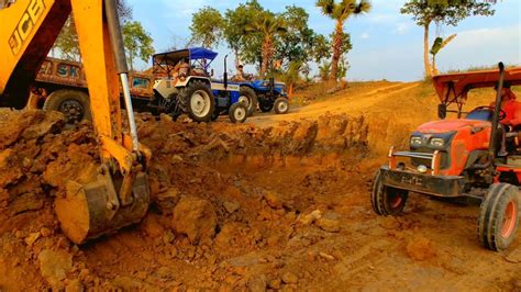 JCB Backhoe Machine Loading Mud In Sonalika Swaraj And Kubota Tractor