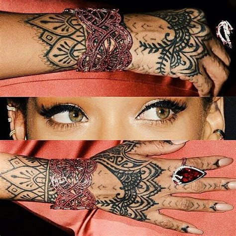 A Woman With Tattoos On Her Arm And Hand Holding Onto The Other Side Of Her Face