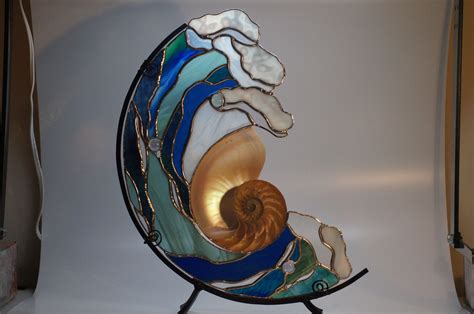 A Glass Sculpture With A Spiral Design On It S Side And An Ocean Wave In The Center