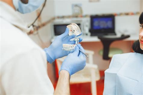 Premium Photo A Male Orthodontist Dentist Shows An Artificial Plastic