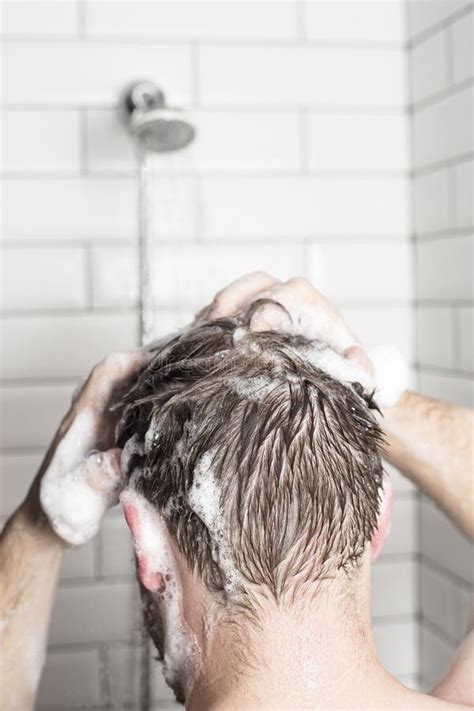 A Man Washing Her Hair With Shampoo In The Shower Room Stock Image