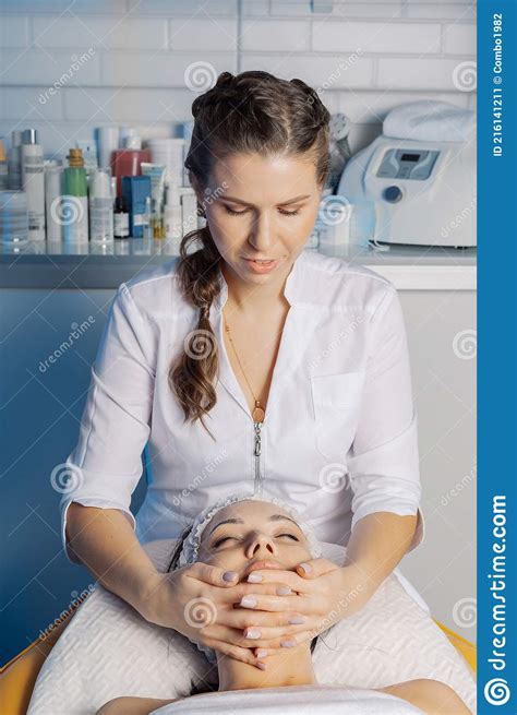 Professional Beautician Makes A Facial Massage To A Woman Stock Image