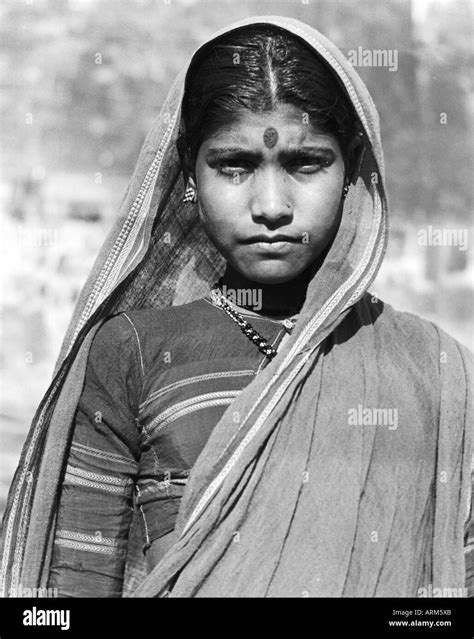 Vrb101250 Indian Woman In Traditional Dress Head Covered Looking At