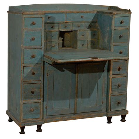 An Old Blue Wooden Desk With Drawers