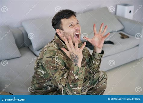 Military Veteran Suffering From Ptsd And Shouting On Sofa Stock Image