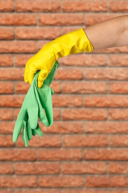 Premium Photo Closeup Of Woman S Hand Wearing Yellow Rubber Glove